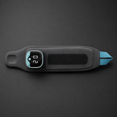 Front view of the EMS Wrist Massager on a user's arm, showcasing the adjustable strap and compact control panel.