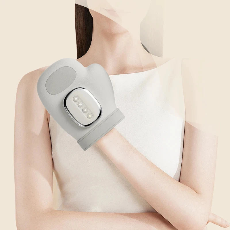 Person using a gray electronic device on their arm against a beige background