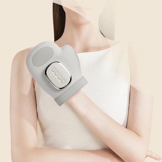 Person using a gray electronic device on their arm against a beige background